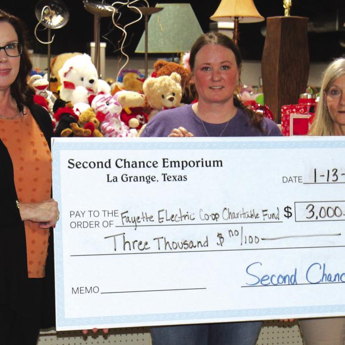 Fayette Electric Cooperative Marketing and Training Coordinator Tracy Denton accepts a grant from Second Chance Emporium representatives Stacy Cada and Gayle Schielack.