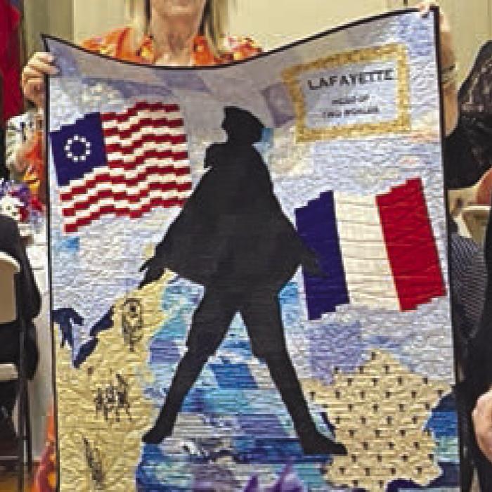 Award winning quilt created by Kay Marburger is presented for viewing.