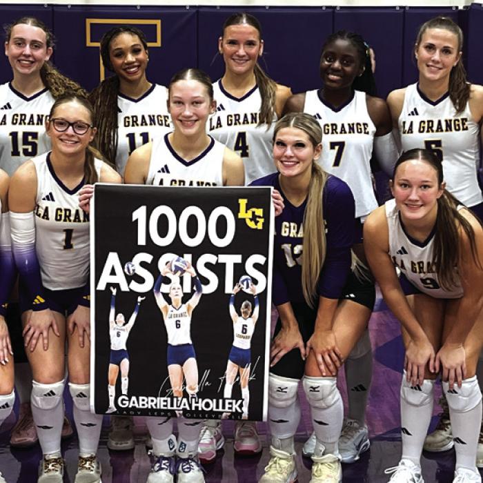 The members of the La Grange volleyball team pose with Gaby Hollek (center, holding banner) as she celebrated earning her 1,000 career assist during Tuesday’s victory over Navasota. Photo by Jeff Wick