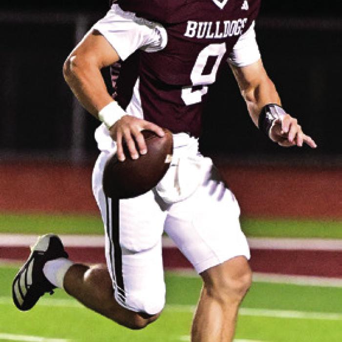 Quarterback Boston Targac looks for an open receiver to pass to in Friday night’s game against Kenedy. Photo by Stephanie Steinhauser
