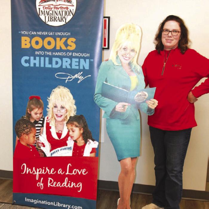 Fayette Electric Cooperative Marketing and Training Manager Tracy Denton poses next to “Dolly” who travels around Fayette and surrounding counties to spread the word about Fayette EC’s partnership with the Dolly Parton Imagination Library.