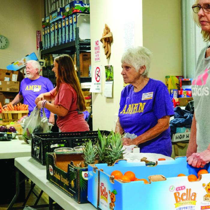 Volunteers at the AMEN Food Pantry in La Grange stand ready to distribute food Monday. The pantry served many more folks than usual. Photo by Andy Behlen