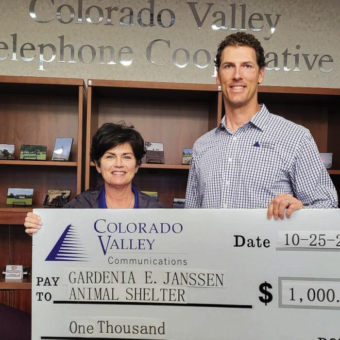 Members of Colorado Valley Telephone Cooperative contributed donations to be presented to the Gardenia E. Janssen Animal Shelter. Pictured from left to right are: Teresa Stanley-Brown, Director of the Gardenia E. Janssen Animal Shelter and Kenn Kasparek, Sales &amp; Marketing Coordinator at Colorado Valley Telephone Cooperative.