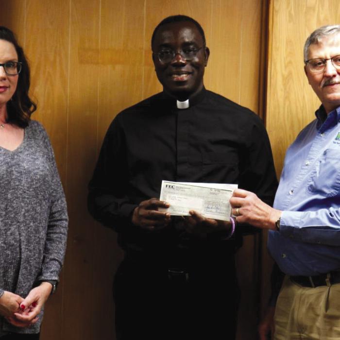 Members of Fayette Electric Cooperative contributed donations to be presented to the Holy Rosary Church Building Fund. Pictured from left to right are: FEC Marketing &amp; Training Coordinator Tracy Denton, Holy Rosary Church Father Felix Twumasi, and FEC General Manager Gary Don Nietsche.