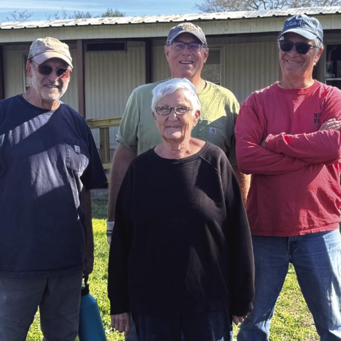 Ms. Bennie Lou Liere and left to right Habitat volunteers Steve Hardin, Matt Holdeman, and Doug Elliott.