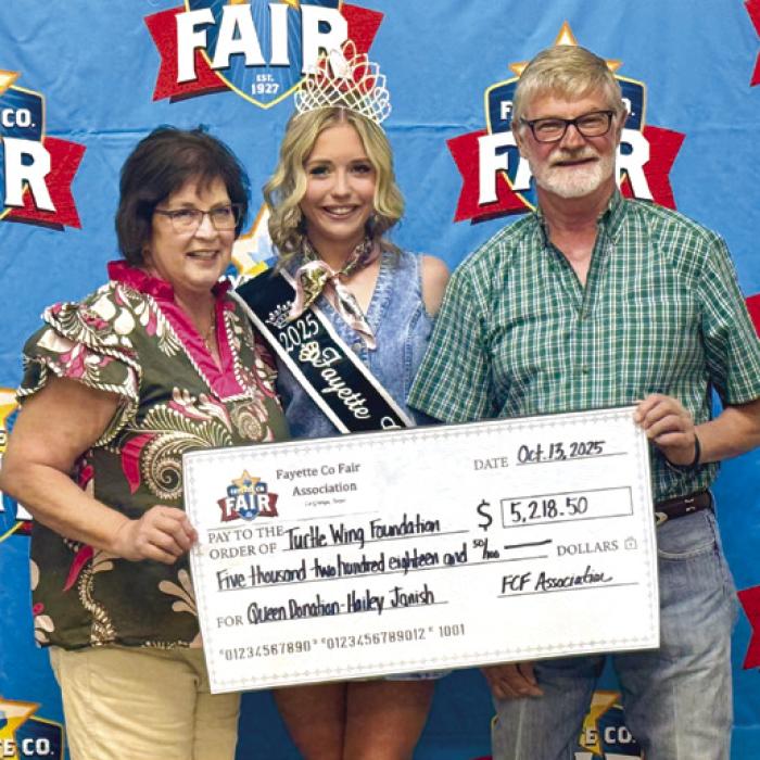 Phyllis Fritsch, Fayette County Fair Queen Hailey Janish and Fayette County Fair Association President Michael Zuhn.