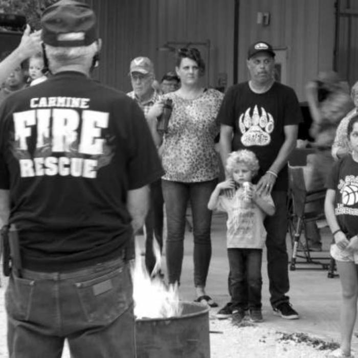 Bruce Bockhorn is shown respectfully burning a flag as part of the Flag Retirement Ceremony, along with some of the people who attended Carmine Night Out. Photos courtesy of Carobeth Bockhorn
