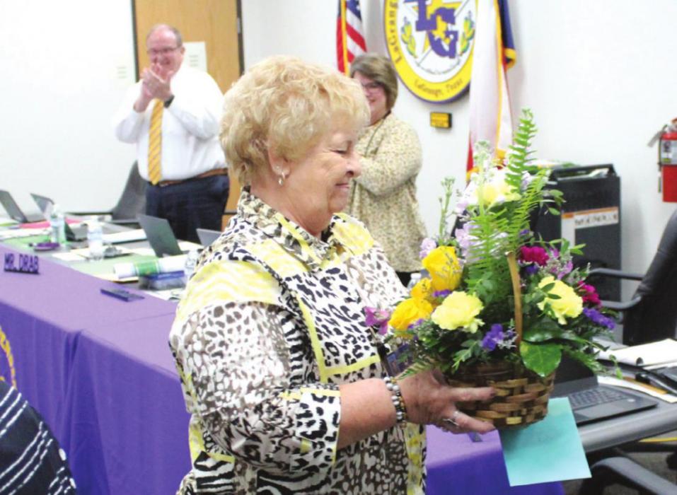 Retiring superintendent secretary Nora Otto got a standing ovation from all in attendance Monday as she walked back to her seat after being presented gifts from the school board. Photo by Jeff Wick