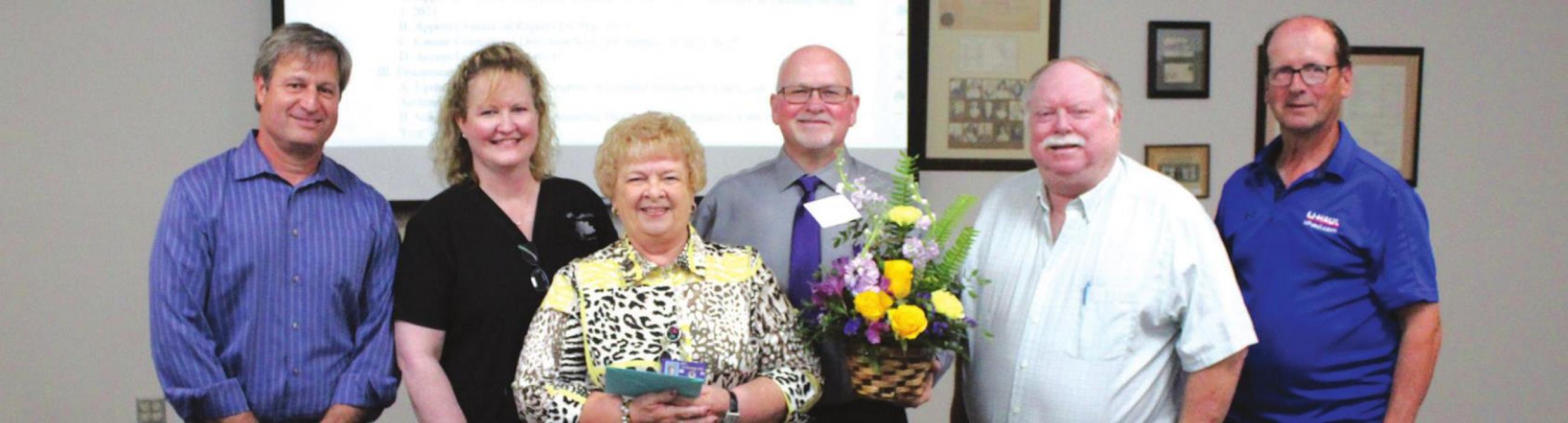The La Grange school board members present retiring secretary Nora Otto with gifts at Monday’s meeting, her last. Left to right: Marc Fitzpatrick, Karen Roberts, Nora Otto, Gary Drab, Greg Trlicek and Calvin Mersiovsky.