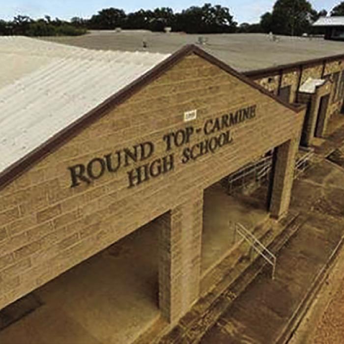 The front of Round Top-Carmine High School. They have a gym from the 1940s and no track.
