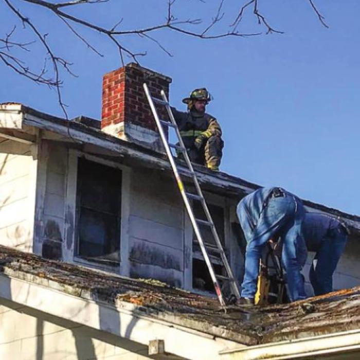 Schulenburg firefighters climbed on a roof to put out a chimney fire on Thursday, March 31. Photo by Schulenburg VFD