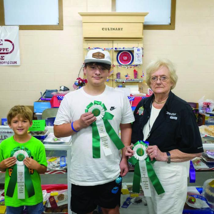 BEST OF THE BAKED GOODS DEPARTMENT From left, Jensen Sutherland won best of department in the child division for a beer bread entry; Joshua Nigh won best of department in the teen division for blueberry crumble bars; Glenna Laffey won best of department in the senior division for angel cake. Not pictured was Emmalee Laffey, who won best of department in the adult division for Italian bread.