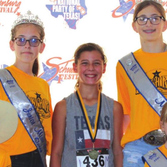 Fastest youth in the mile: Norah Dean with 7:48, shown here with the Festival royalty.