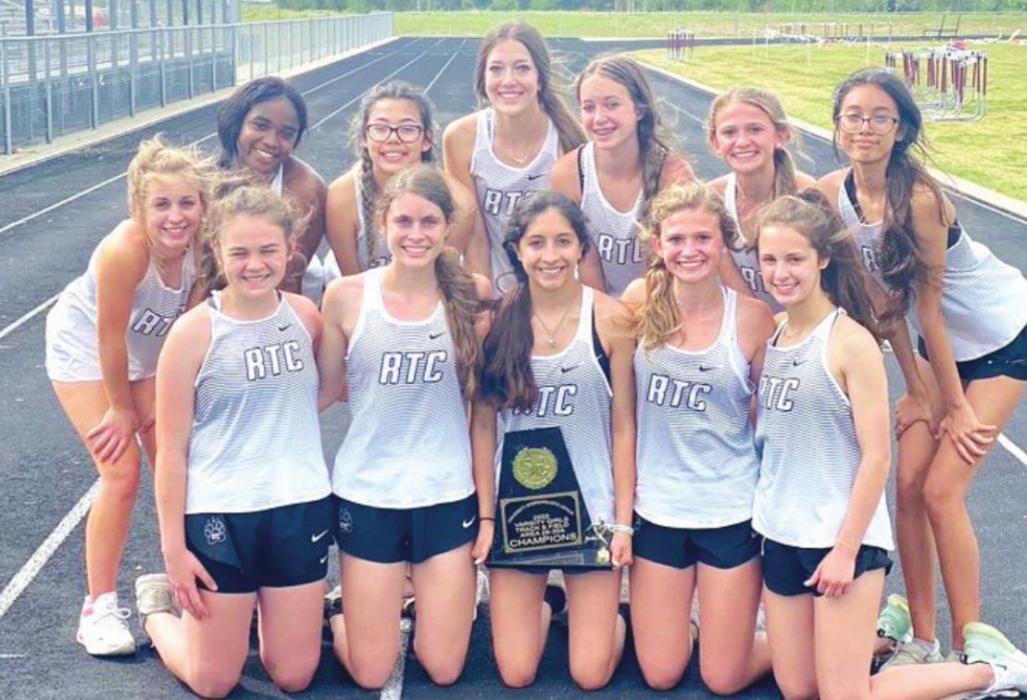 The members of the Round Top-Carmine girls track team are shown above holding their area team track title trophy.