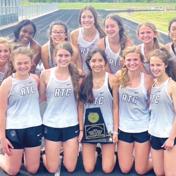 The members of the Round Top-Carmine girls track team are shown above holding their area team track title trophy.