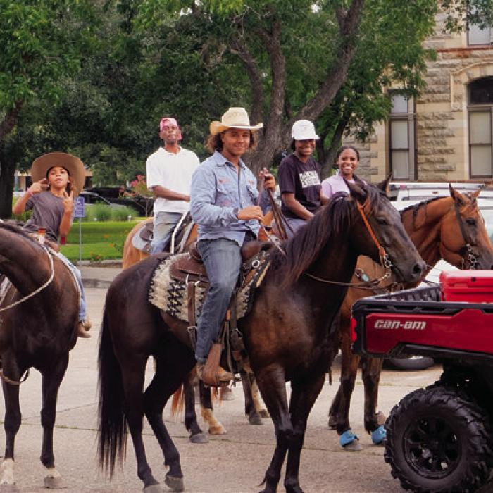 The Juneteenth trail riders pose for the camera during a pause in the parade in front of the courthouse. More photos on Page A6 today. Photo by Andy Behlen