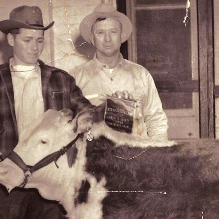Glen Prause Sr. is shown here standing in front of Prause Market with a grand champion show calf held by Morris Zapalac. Jimmy Prause, Glen’s brother, is standing in the far left of the photo in the doorway of the meat market. This picture was taken in 1940’s. They are the second generation of Prauses to run the market after it had moved to the east side of the courthouse square.