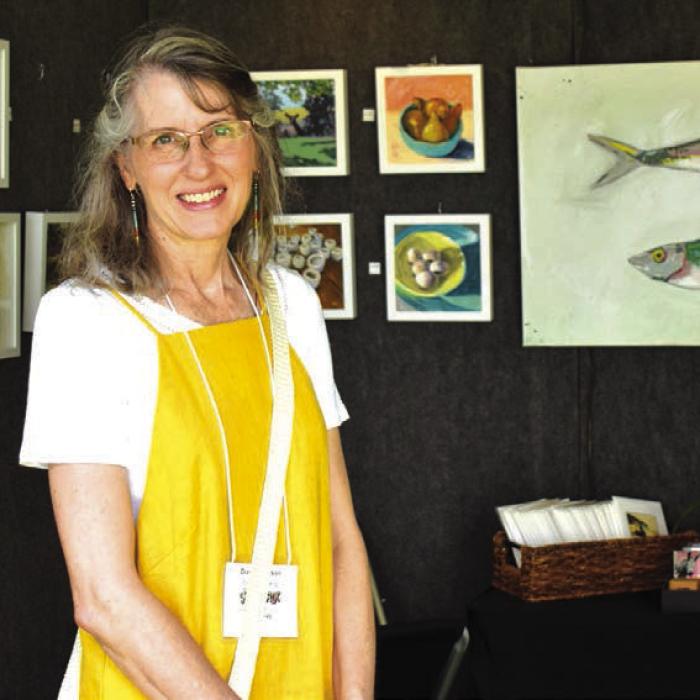 Diane Peterson with her booth at last year’s ArtWalk.