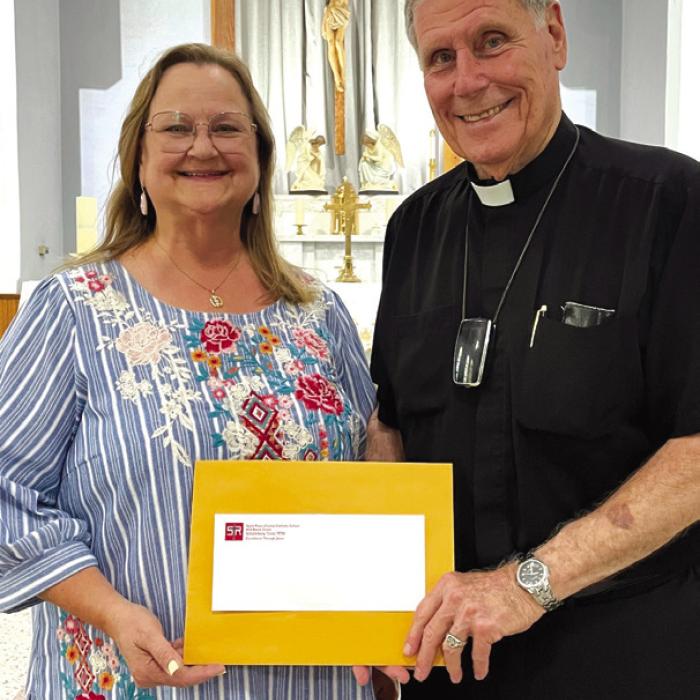 Rosanne Gallia and St. Rose of Lima Catholic Church Pastor Father Jasper Liggio.