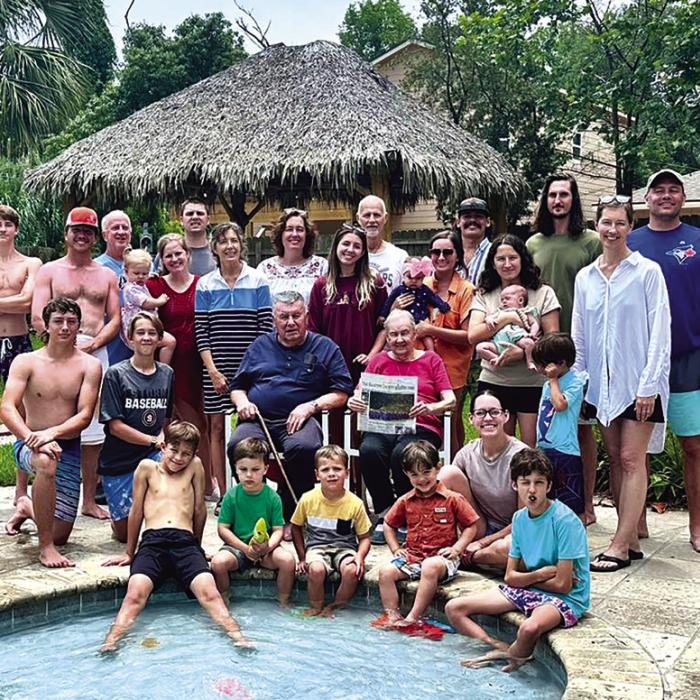 For the 27th consecutive year, members of the Leo and Barbara Wick family of La Grange descended on the Texas coast for a beach trip. When not fishing or playing dominos, volleyball or bananagrams, they enjoyed reading The Fayette County Record, held here by Barbara Wick. Shown above are 29 of the 33 attendees who all, somehow, crammed into one massive property near Dickinson. Photo by Chrystal Wick