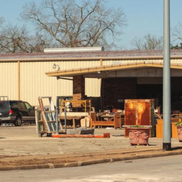 A speaker at Monday’s meeting complained about how the old bowling alley’s parking lot has been turned into an antiques showcase. Photo by Andy Behlen