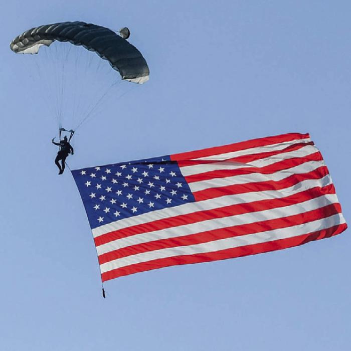 Parachutist David Moore of the Texas Skydiving team descended with a 1,000 sq. ft. American flag Friday before landing at Frisch Auf! Golf Course in La Grange, part of the a slew of local activities over the weekend, that all celebrated America’s 250th Birthday. Lots more in Section B today. Photo by Andy Behlen