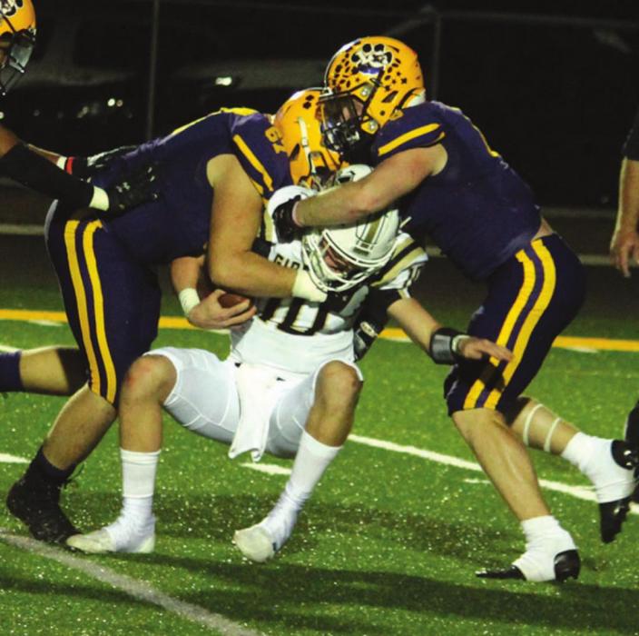 La Grange’s Cooper Imhoff, left, and Ryder Imhoff, right, combine to sack Giddings quarterback Holden Jatzlau Friday. Photo by Jeff Wick