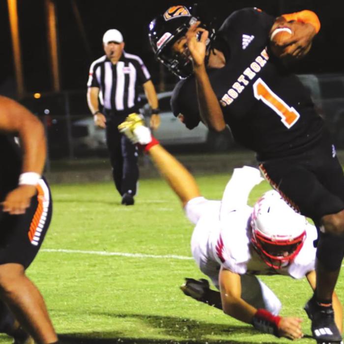 Schulenburg’s Kenny King shows off some real flexibility to get away from this St. Paul tackler. Photo by Audrey Kristynik