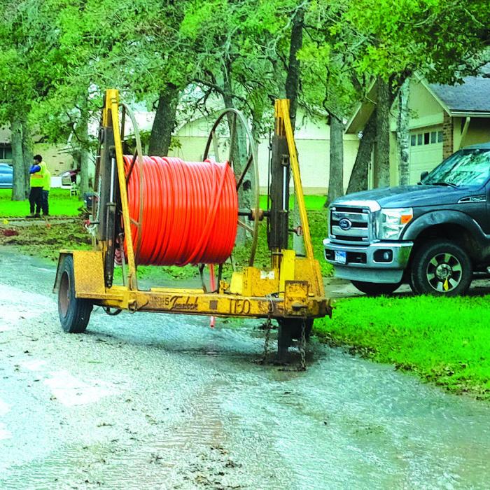 A small river of water runs down Molly Rd. in the Bluff Haven neighborhood Wednesday morning after a boring crew struck a water line near the intersection of Richard Rd. Photo by Andy Behlen