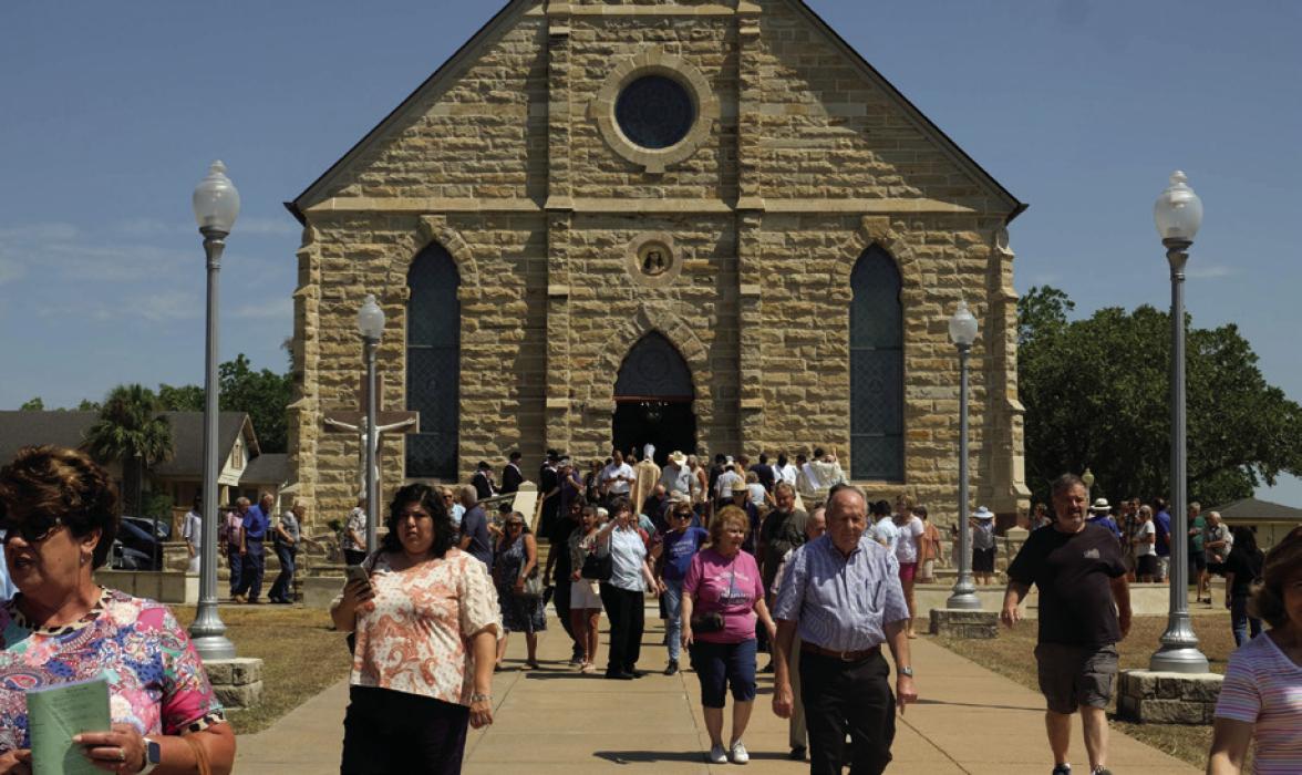The crowd of faithful leave The Assumption of the Blessed Virgin Mary Catholic Church in Praha at the conclusion of mass at the picnic on Aug. 15, which is the feast day for the parish and a Holy Day of Obligation for Catholics.