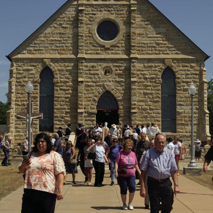 The crowd of faithful leave The Assumption of the Blessed Virgin Mary Catholic Church in Praha at the conclusion of mass at the picnic on Aug. 15, which is the feast day for the parish and a Holy Day of Obligation for Catholics.