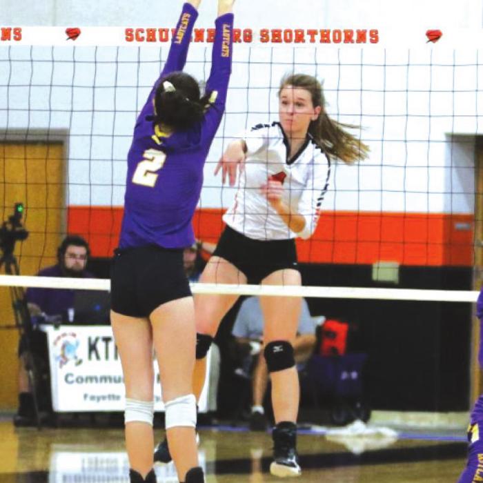 Schulenburg’s Jordan Sommer spikes the ball past a Weimar player in Tuesday’s match. Photo by Audrey Kristynik