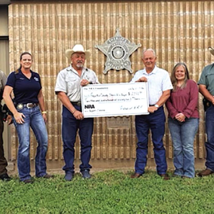 Deputies receiving the grant check, left to right are-Deputy Herman Olvera, Sgt. Ron Naumann, Sgt. Angela Lala,, Sheriff Keith Korenek, Dennis Brower-Friends of NRA, Renee Moreland, Lt. David Beyer, and Deputy Joe Gonzales.