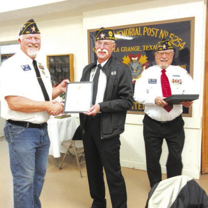 The American Legion Bronze Medal was awarded to John Battle for his work supporting parade entries and participating in ceremonies at the Fayette County Fair by Post Commander Richard Gray, with Awards Committee Chair Glenn Altwein.