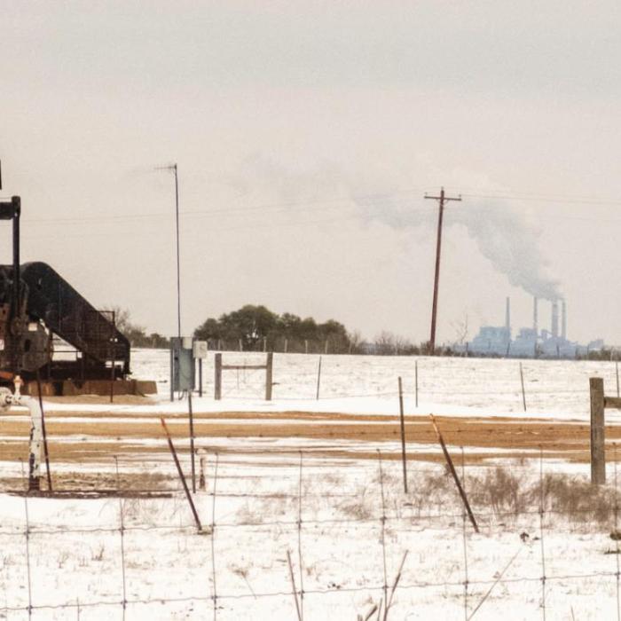 A pump jack on East Radhost School Road stood idle last Tuesday as a plume of steam rises from the Fayette Power Project in the background.