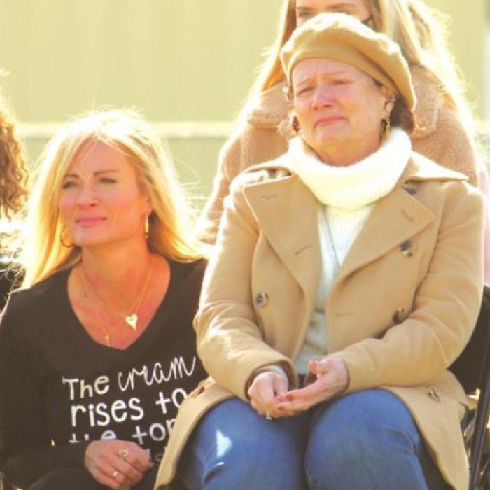 David Husmann’s eldest daughter Angie Ebrey consoles her mom Karen during an emotional part of the Saturday’s ceremony.