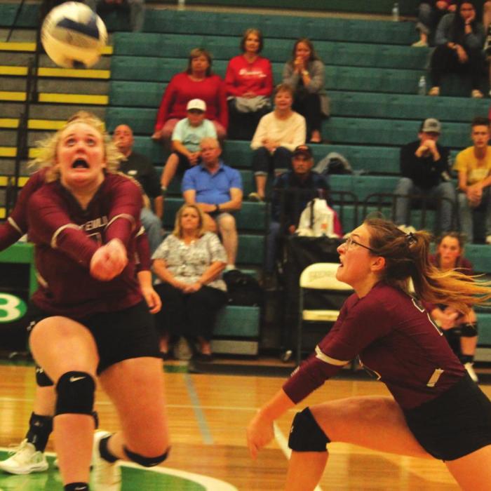 Fayetteville teammates Peyton Jurecka, left, and Marissa Rohde, right, are ready to dig this ball in Monday’s playoff match. Photos by Jeff Wick