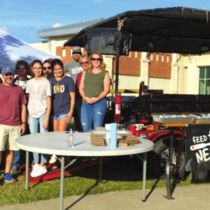 Crosspoint Community Church’s Feed the Need mission group takes a quick break from readying the freshly grilled meal for St. Mark’s Medical Center staff and their families.