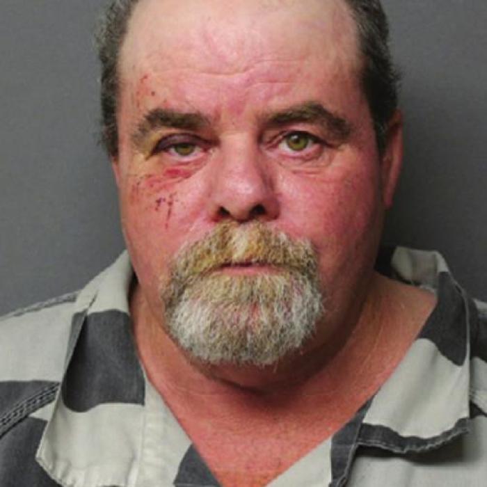 Shawn Patrick Childers (right), 53 of La Grange, was arrested on Thursday for allegedly robbing the Burton State Bank at gunpoint two years ago. The photo on the left comes from the surveillance video at the bank on the day of the robbery.