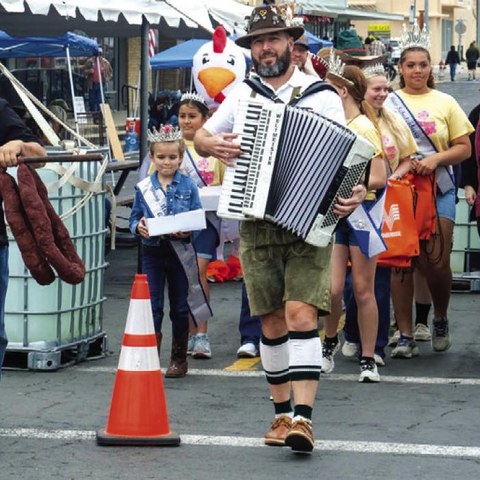 Rodney Kalich of the Sausagefest Committee and local musician Dave “Superdave” Hollas led the walking parade at the beginning of Saturday’s festival in downtown Schulenburg. More pics of Sausagefest fun appear today on page B2. Photo by Andy Behlen