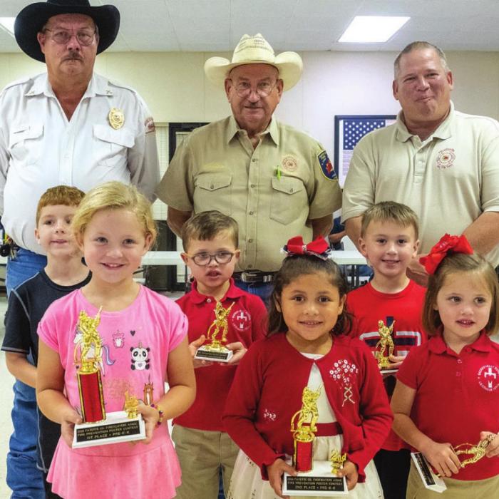Fire poster contest winners for Pre-K and Kindergarten are (front, from left) first place - Stella Mozisek of La Grange, second place - Patsy Lemus of La Grange, third place - Macy Hodges of La Grange, (middle) third honorable mention - Adam Reeves of Schulenburg, second honorable mention - Cole Hodges of La Grange, first honorable mention - Brayden Rainosek of Schulenburg, (back) Keith Burcalow, Randy Noviskie and Kenneth Chovanec of the Fayette County Firefighters Association.