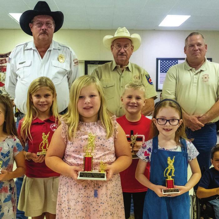 Fire poster contest winners for 1st and 2nd grade are (front, from left) first place - Avery Havel of Fayetteville, second place - Olivia Otto of Schulenburg, third place - Audrey Pietsch of La Grange, (middle) third honorable mention - Marley Vasek of La Grange, second honorable mention - Brody Brossmann of Schulenburg, first honorable mention - Benjamin Garlick of La Grange, (back) Keith Burcalow, Randy Noviskie and Kenneth Chovanec of the Fayette County Firefighters Association.
