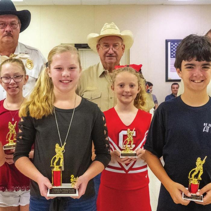 Fire poster contest winners for 5th and 6th grades are (front, from left) first place - Bo Brossmann of Schulenburg, second place - Madison Markwardt of La Grange, third place - Caden Tovey of Round Top, (middle) third honorable mention - Kenlie Jo Kallus of La Grange, second honorable mention - Caroline Bartek of Schulenburg, first honorable mention - Presley Cliffe of Flatonia, (back) Keith Burcalow, Randy Noviskie and Kenneth Chovanec of the Fayette County Firefighters Association.
