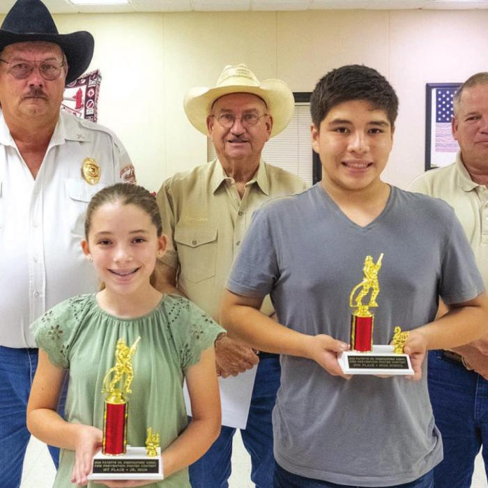 Fire poster contest winners for junior high and high school are (front, from left) first place junior high - Emily Keilers of Fayetteville, second place high school - Daniel Lazcano of Fayetteville, (back) Keith Burcalow, Randy Noviskie and Kenneth Chovanec of the Fayette County Firefighters Association. Not pictured were first place high school - Rylie Dyer of Fayetteville and third place high school Kaitlyn Witt of Fayetteville.