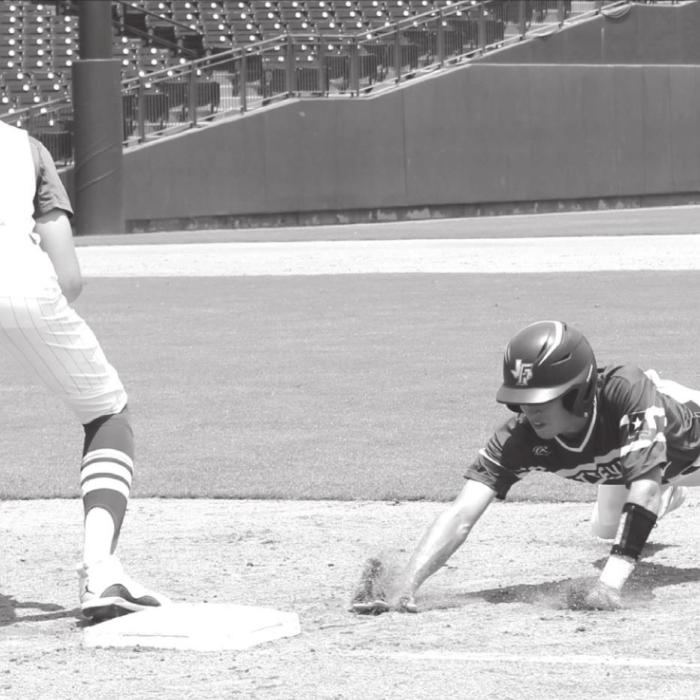 Fayetteville’s Keagan Supak dives back into first base during a pick-off attempt Wednesday.