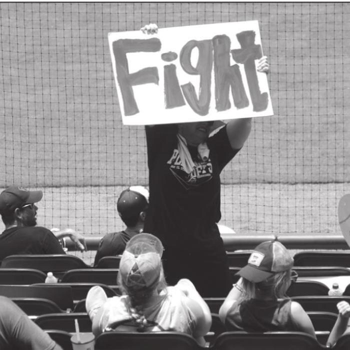 A Fayetteville fan holds up a sign Wednesday.