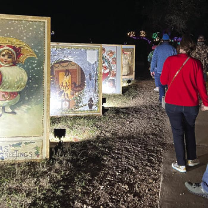 Huge Victorian Christmas cards line a walkway at Trail of Lights.