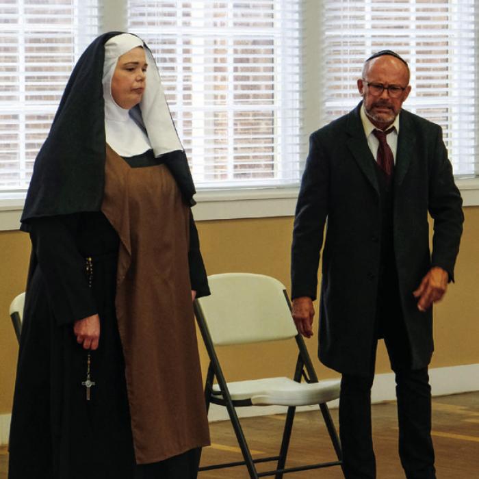 Kristen Holub as Prioress (left) and Aaron Rainey as Dr. Saul Weisman (right) rehearse their parts for Fayette County Community Theatre’s production of “Edith Stein.” Photo by Andy Behlen
