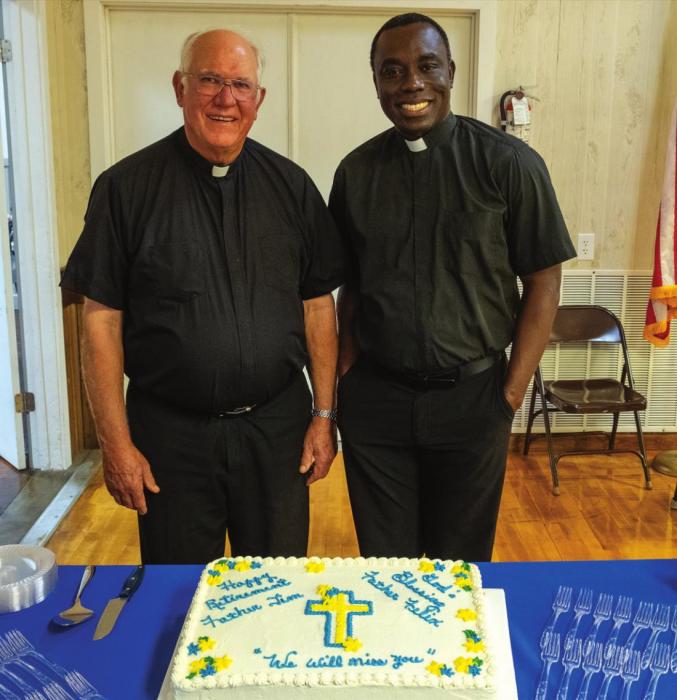 Parishoners of St. Rose in Schulenburg presented Msgr. Tim Kosler and Rev. Felix Twumasi with a cake at the reception Wednesday. Photo by Andy Behlen
