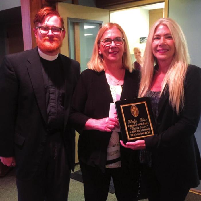 A plaque was presented to Gladys Giese’s daughters after her funeral on Monday. The plaque was in honor of the many years of Giese telling the world about Warda in the weekly news column. Pictured are Pastor Beck, Roxanne Davis and Robin Wedgeworth.